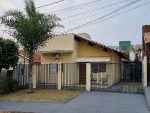 a yellow house with a fence and a tree at Atlantico Residencial in Bonito