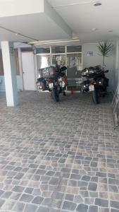 a group of motorcycles parked in a garage at HOTEL AREQUIPA ANDINOS in Arequipa