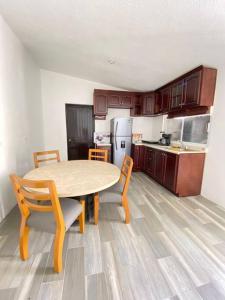 a kitchen with a table and chairs in a room at Casa para vacacionar in Cabo San Lucas