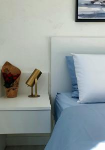 a bedroom with two beds and a lamp on a night stand at Negotin Centar Apartman II in Negotin