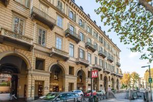 a large building with cars parked in front of it at Vittorio 73 Luxury Apartment in Turin