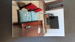 a room with a kitchen with a refrigerator at 椿リゾートみさき in Shirahama