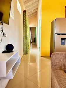a hallway with a refrigerator in a room at Cozy Modern Upstairs 2 Bed A/C Apt Near 2 Everything in Saint Philip