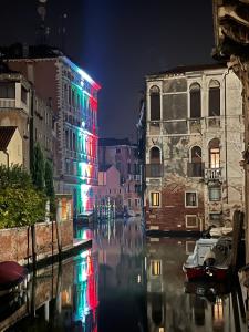 a view of a canal at night with buildings at Admiral Home Venice Center in Venice