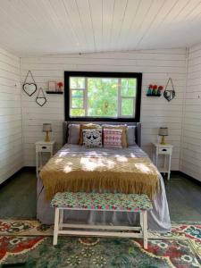 a bedroom with a bed with two tables and a window at Riverside in Tazewell