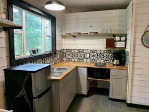 a small kitchen with a counter and a sink at Riverside in Tazewell