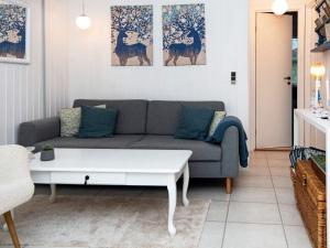 a living room with a couch and a coffee table at 4 person holiday home in Hejls in Hejls