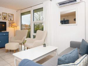 a living room with a couch and chairs and a table at 4 person holiday home in Hejls in Hejls