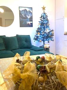 a living room with a christmas tree and a table at Apartmán Klára in Terchová