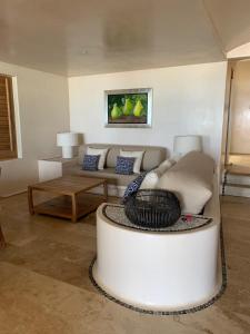 a living room with a couch and a table at New Beachfront Villa in Playa Blanca in Zihuatanejo