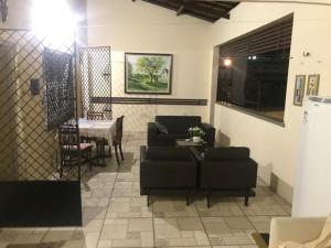 a living room with a couch and a table at Pousada Suítes Meireles in Fortaleza