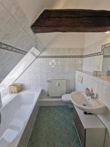 a bathroom with a tub and a sink and a toilet at Fewo Wolgast Usedom Ostsee in Wolgast