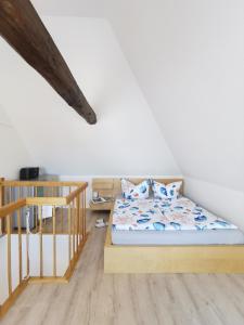 a bedroom with a bed and a staircase in a room at Fewo Wolgast Usedom Ostsee in Wolgast