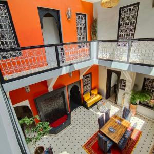 an overhead view of a living room with an orange wall at Riad Mylaya in Marrakesh