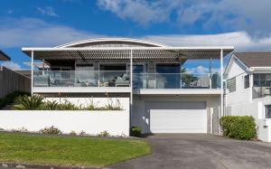 a modern house with a glass facade at The Ocean Outlook Pure Luxury in New Plymouth