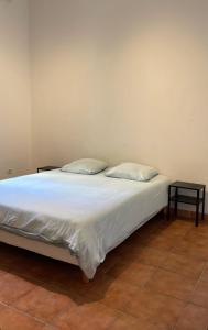 a bed with two pillows on it in a room at T2 vue mer CATALANS - NETFLIX - VELODROME in Marseille