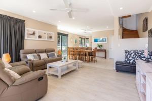 a living room with a couch and a table at Boom 1 in Blueys Beach