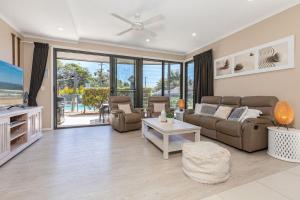 a living room with a couch and a table at Boom 1 in Blueys Beach