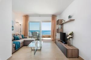 a living room with a couch and a glass table at Apartamento Panorama Mar in Punta Prima
