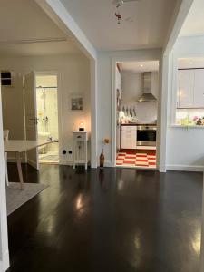 a large living room with a table and a kitchen at Apartment in the middle of So-Fo, Södermalm, 67sqm in Stockholm