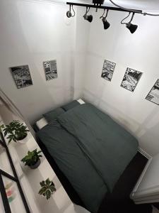 a small room with a green bed in it at Apartment in the middle of So-Fo, Södermalm, 67sqm in Stockholm