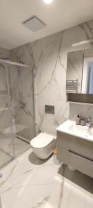 a bathroom with a toilet and a sink and a shower at Diamond Apartment 158- Luxury in Skopje in Skopje
