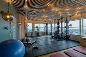 a gym with exercise equipment in a room with windows at Scandic Plaza Umeå in Umeå