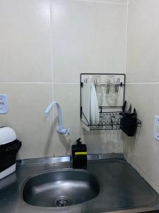 a bathroom with a sink and a telephone at SOL in Búzios