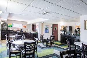 a restaurant with tables and chairs and a counter at Quality Inn Saraland in Saraland