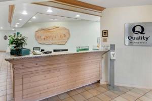 a lobby of a quality store with a counter at Quality Suites Moab near Arches National Park in Moab