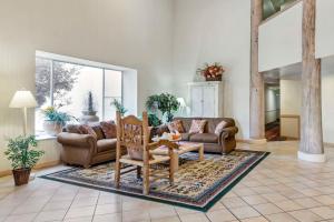 a living room with a couch and a chair at Quality Suites Moab near Arches National Park in Moab