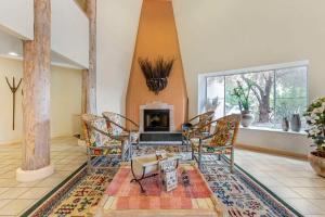 a living room with chairs and a fireplace at Quality Suites Moab near Arches National Park in Moab +23 photos