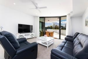 a living room with two couches and a tv at Solaris 310 in Forster