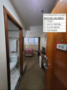 a bathroom with a toilet and a sign on the door at 512. Flat hotel Go Inn in Brasilia