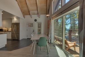 a kitchen and dining room with a table and chairs at Moon Dune Chalet, Remodeled 3 BR Cabin plus Loft, Walk to Dining in Tahoe Vista