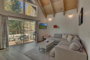 a living room with a couch and a table at Moon Dune Chalet by Tahoe Getaways - Remodeled 3 BR Cabin plus Loft w Fenced Yard & Walk to Beach or Dining in Tahoe Vista
