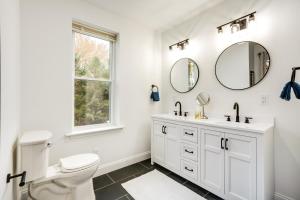 a white bathroom with a toilet and a sink at Family-Friendly Hatfield Home 3 Mi to Downtown! in Hatfield +22 photos