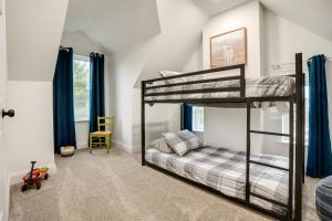 a bedroom with two bunk beds and a chair at Family-Friendly Hatfield Home 3 Mi to Downtown! in Hatfield