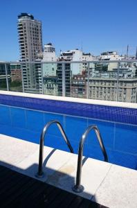a swimming pool with a view of a city at Estudio VIP en Recoleta in Buenos Aires