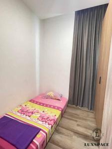 a small bed in a room with a window at Kuching City 3rd Mile Batu Kawa Cozy Apartment in Kuching