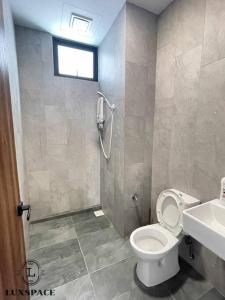 a bathroom with a toilet and a shower and a sink at Kuching City 3rd Mile Batu Kawa Cozy Apartment in Kuching