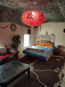 a bedroom with a bed and a red lantern at Café Autor Dan et Eger Nouvelle Restaurant in Ouzoud