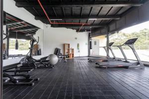 a gym with several treadmills and cardio machines at Hermoso loft en Llanogrande in Rionegro