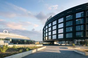 a large glass building with a building at STAGES HOTEL Prague, a Tribute Portfolio Hotel in Prague