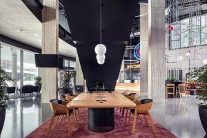 a conference room with a wooden table and chairs at STAGES HOTEL Prague, a Tribute Portfolio Hotel in Prague