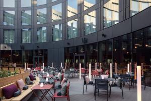 a patio with tables and chairs in front of a building at STAGES HOTEL Prague, a Tribute Portfolio Hotel in Prague