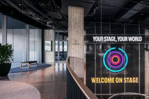 a lobby with a sign that reads welcome on stage at STAGES HOTEL Prague, a Tribute Portfolio Hotel in Prague