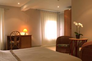 Postel nebo postele na pokoji v ubytování Hotel Le Beau Séjour