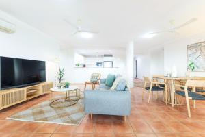a living room with a couch and a table at Harbour Haven - A Parkside CBD Address in Larrakeyah