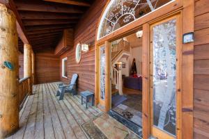 a porch of a log cabin with a wooden wall at Fox Crossing at Tahoe Donner Vacation Rental w Forested Views in a Prime Location in Truckee